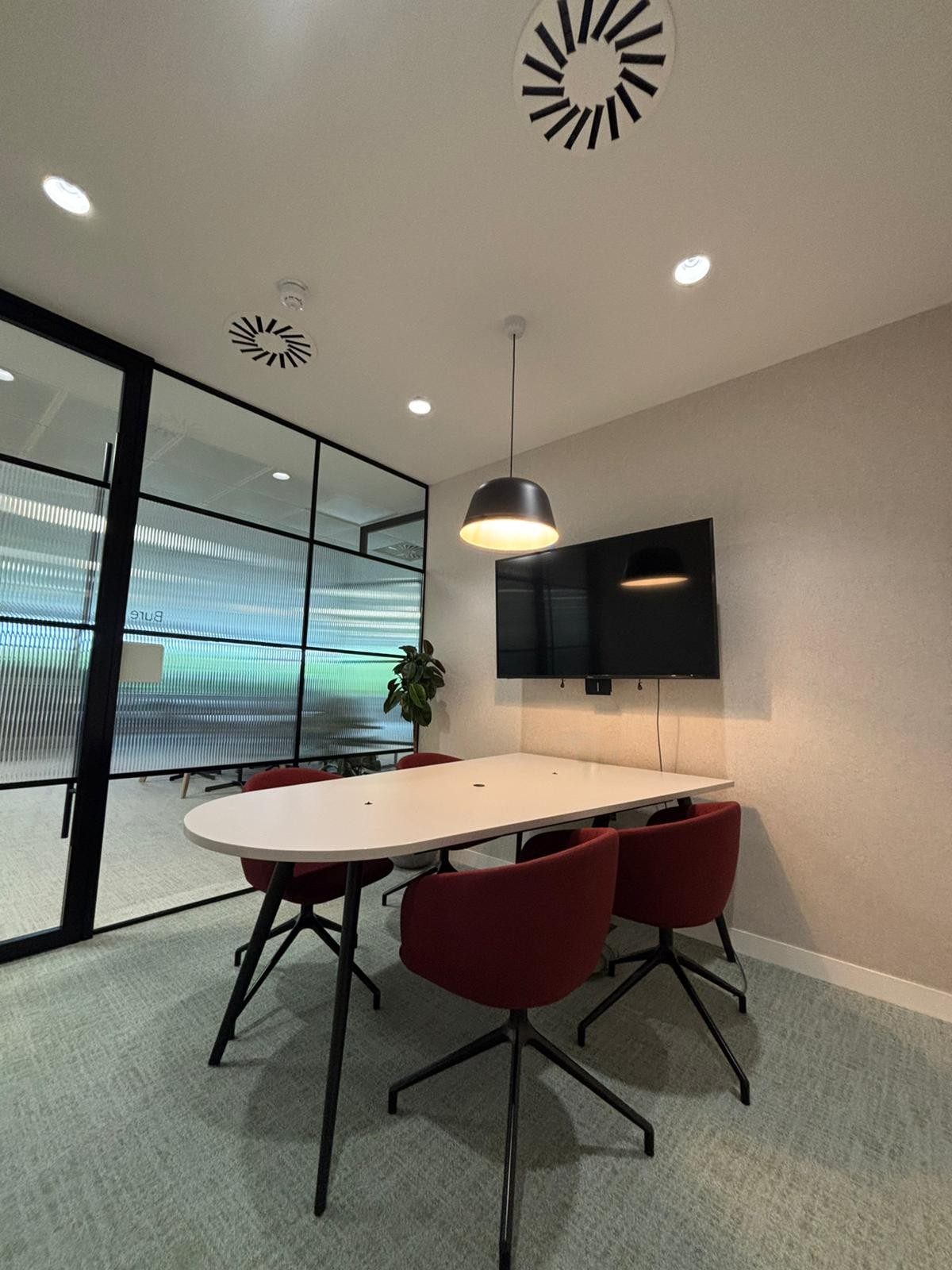 Finished Norwich office meeting room with ceiling downlights, a pendant and room-service provision