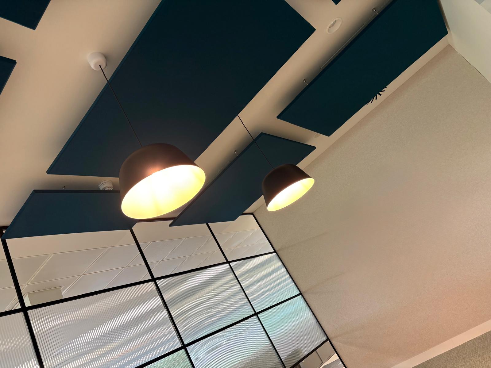 Pendant lighting and ceiling services within a finished meeting space